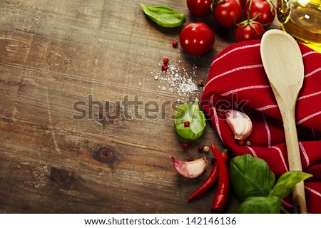 Wooden spoon and ingredients on old table