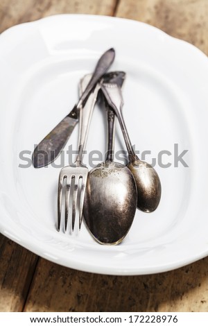 Vintage silverware on a plate