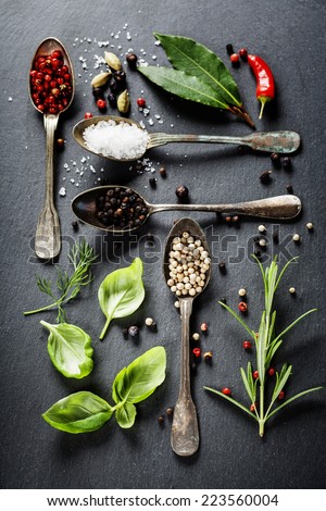 Herbs and spices selection - herbs and spices, old metal spoons and slate background - cooking, healthy eating