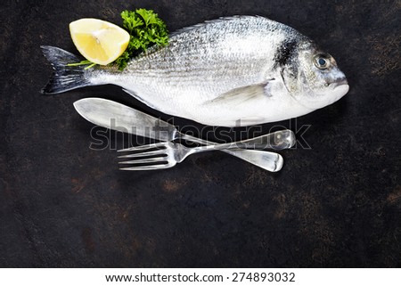 Delicious fresh fish on dark vintage background