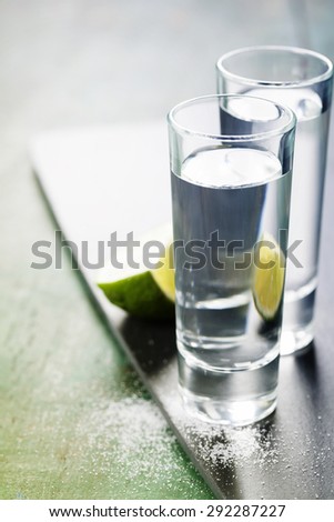 Tequila shots with lime and salt on rustic  background