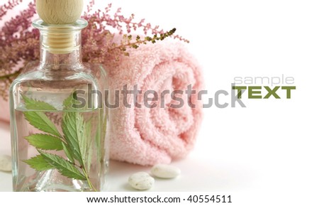 Jar with fresh leaves and towel (SPA concept). With sample text