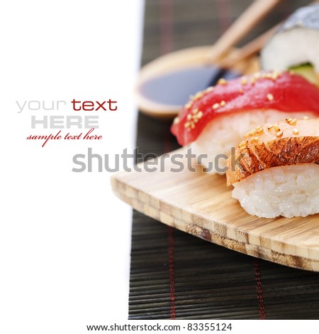 set of japanese sushi with chopsticks and soy sause over white with sample text