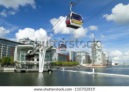 LONDON, UK - AUG 4: Visitors travel on the Emirates cable car. The service is London??s first urban cable car which crosses the Thames from Excel centre to the O2 on August 4, 2012 in London UK