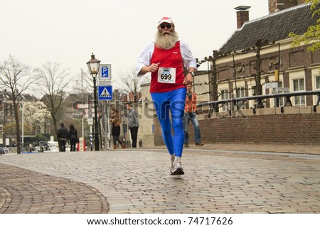 DORDRECHT, THE NETHERLANDS - APRIL 3: runner in \'Dwars door Dort\' 10km race for all ages, in Dordrecht, The Netherlands on April 3, 2011