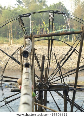 Bamboo water wheel. The use of water power for irrigation.Thailand