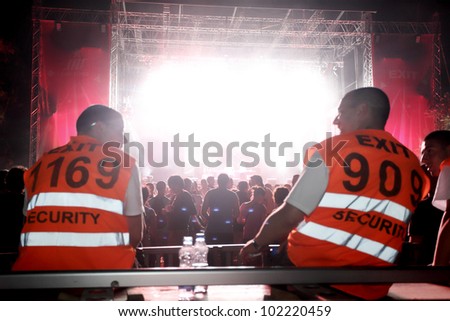 NOVI SAD, SERBIA - JULY 8, Security guards overlook the Main stage at EXIT 2011 Music Festival, on July 8, 2011 in the Petrovaradin Fortress in Novi Sad.