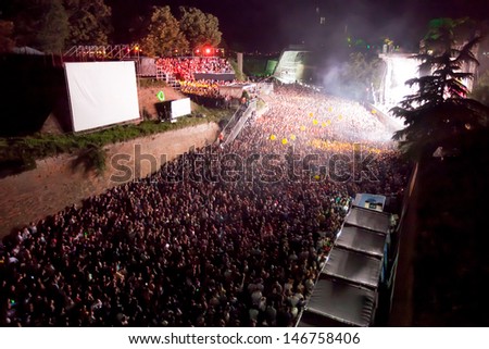 NOVI SAD, SERBIA - JULY 11: Audience in front of the Dance Arena at EXIT 2013 Music Festival, during Fat Boy Slim\'s performance on July 11, 2013 in the Petrovaradin Fortress in Novi Sad.