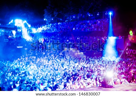 NOVI SAD, SERBIA - JULY 12: Audiece in front of the Dance Arena at EXIT 2013 Music Festival, during Jeff Mills\' performance on July 12, 2013 in the Petrovaradin Fortress in Novi Sad.