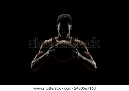 African american young athletic woman, curly hairstyle, running outdoors in the city, corridor Urban sports in the city. Sunset time with shadows. Serious woman concentrating in the competition train.