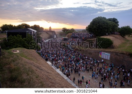 NOVI SAD, SERBIA - JULY 11 2015: Audience infront of the Dance Arena at EXIT 2015 Music Festival, during sunrise, on July 11, 2015 at the Petrovaradin Fortress in Novi Sad, Serbia.