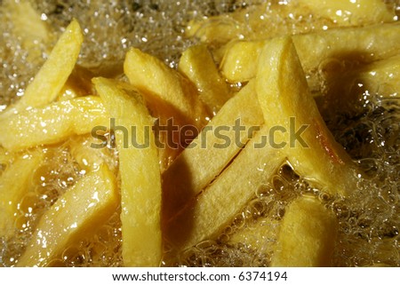 french fries - chips baking in oil, close up photo