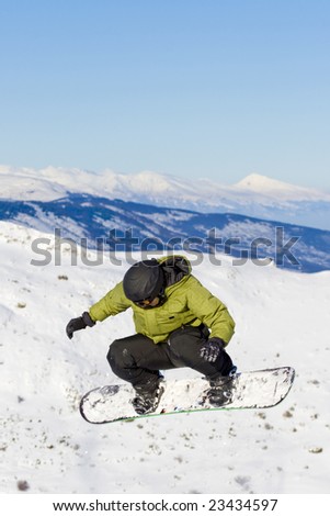 boy snowboarding caught in a jump