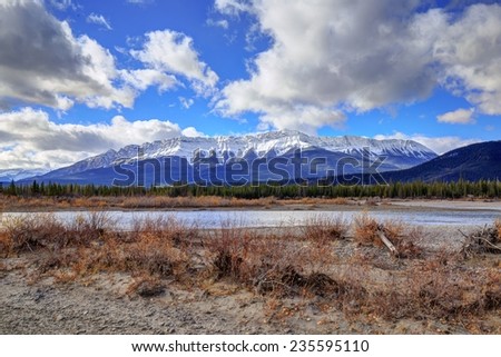 autumn colors of Athabasca River with Roche De Smet Mountain in the background, Jasper National Park, Alberta, Canada