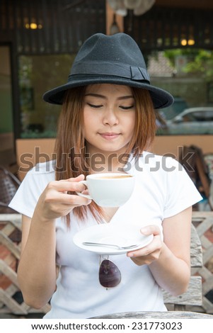 woman drinking coffee  at coffee shop (soft focus on eyes)