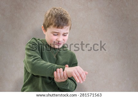 Boy in Pain Holding His Wrist