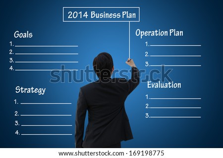 Businessman writing 2014 business plan present by blank or empty chart