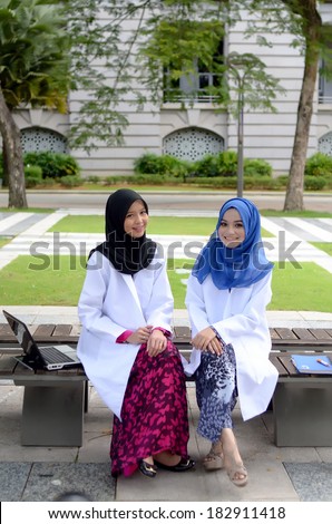 Confident Muslim medical student busy conversation at park
