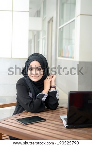 Young asian muslim woman in head scarf smile