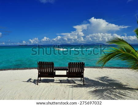 Chairs at beauty seascape under blue clouds sky