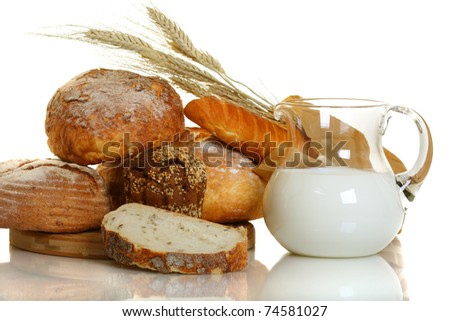 Fresh bread and milk in a glass jar on white background.