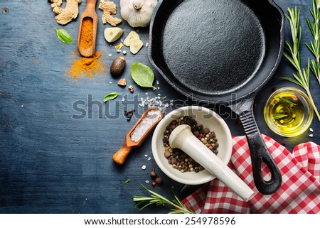 Ingredients for cooking and empty cast iron skillet, pepper and spices. Food background  with copyspace