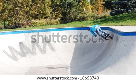 boy riding bmx bike at the skateboard park