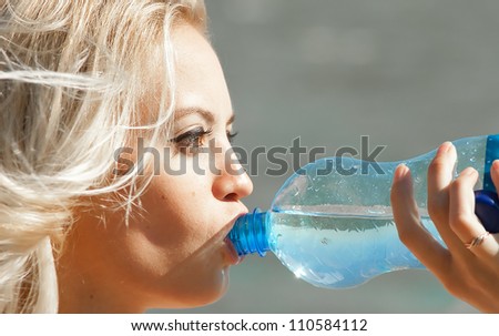Girl drinking water on a sunny day