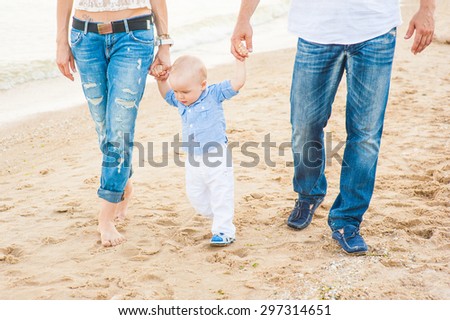 The family of a man a woman and child walking on the beach and breathe the sea air