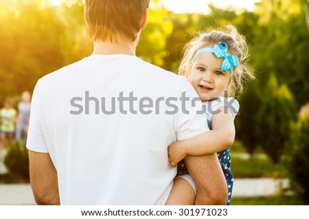 Girl sitting on the arms of man and feels peace and tranquility