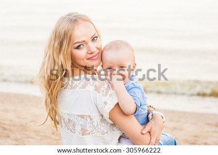 A woman holding a child and feels the joy and unity