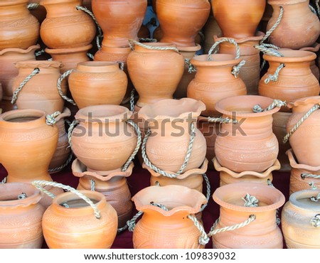 Thai clay pots on the rack of beverage shop.