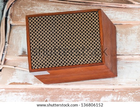 Retro style speaker box on the wall of old house.