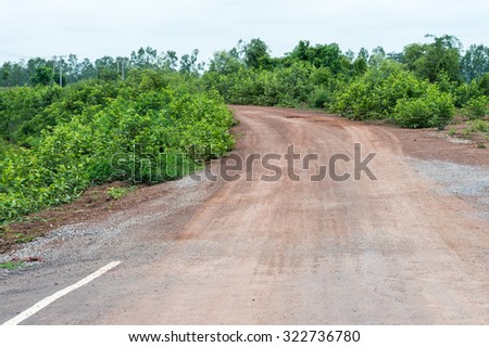 End of the asphalt road to the gravel road in countryside of Thailand.