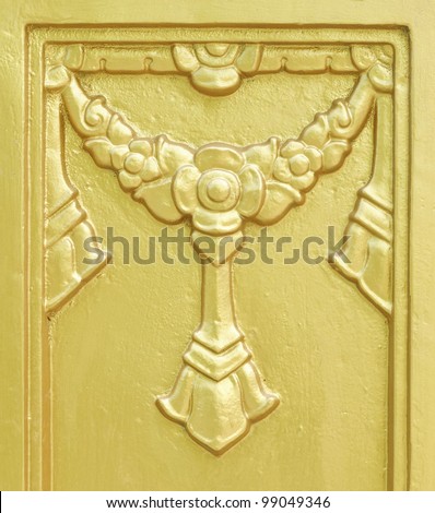 Golden cement frame on the wall of Thai temple.