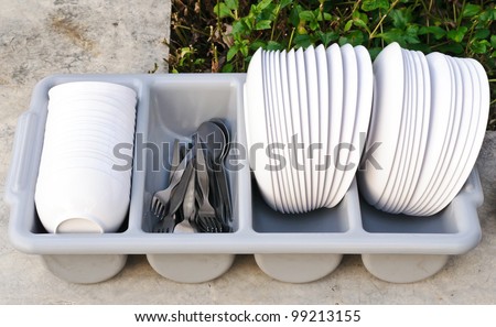 Clean food ware in plastic basket for service.