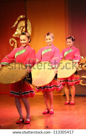 GUANGZI, CHINA - SEPTEMBER 18 : Unidentified minority dancers with traditional clothes perform local dance called Welcome Home show on stage on September 18, 2011 in Guangzi Zhuang Autonomous Region, China.