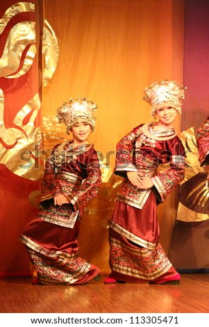 GUANGZI, CHINA - SEPTEMBER 18 : Unidentified minority dancers with traditional clothes perform local dance called Welcome Home show on stage on September 18, 2011 in Guangzi Zhuang Autonomous Region, China.