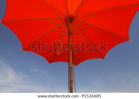 red umbrella in a clear blue sky