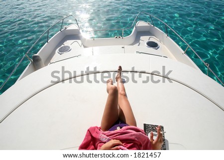 woman legs on the roof of a catamaran boat