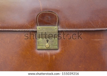 Close-up of lock on leather business case ,for background