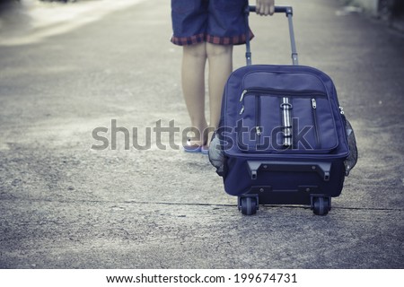 schoolgirl walk alone to school with school bag