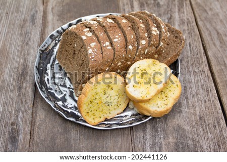 Grain bread, Garlic bread on old wood background