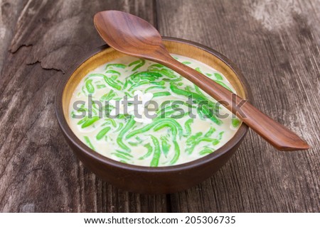 Thai dessert, rice noodles made of rice eaten with coconut milk on old wood table