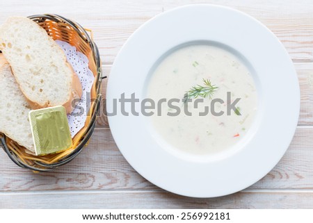 Top view - Fluffy herb soup with salmon in a white plate