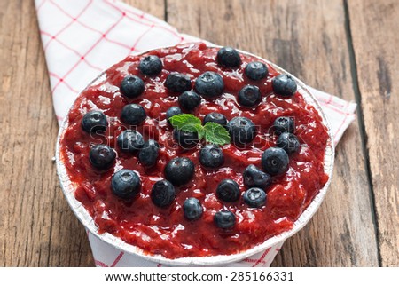 Strawberry cheese pie with fresh blueberry on wood