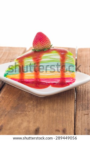 Rainbow crepe cake with strawberry juice and fresh strawberry on top