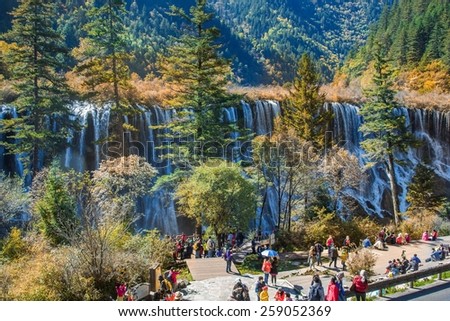 SICHUAN, CHINA - OCTOBER 21, 2014 : Tourist visit the Nuorilang Waterfall in Jiuzhaigou National Park scenery spot on October 21, 2014 in Jiuzhaigou, Sichuan, China.