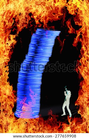 financial crisis concept with businessman and coin heap fire frame