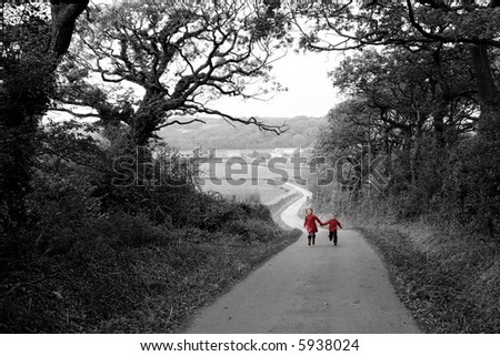 Children in red coats running up farm road